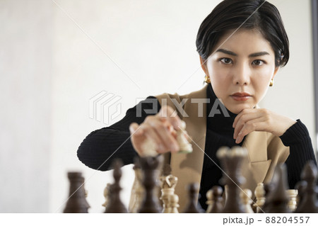 チェスの駒を動かす若い女性 88204557