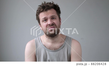 Sad young man looking at camera is about to cry. Sad young man looking at camera is about to cry. 88206428