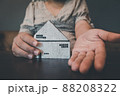 Housing Loan and Real Estate Broker Selling Agency Concept. Business Woman Hands Offer House Model to Customer for Sale,Rent. Business House Realty Agent and Residential Investment. 88208322