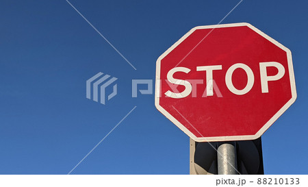 Stop sign on blue sky background. Red sign with the inscription stop. Place for text. Copy space. Copy space. Place for text. Stop sign on blue sky background. Red sign with the inscription stop. Place for text. Copy space. Copy space. Place for text. 88210133