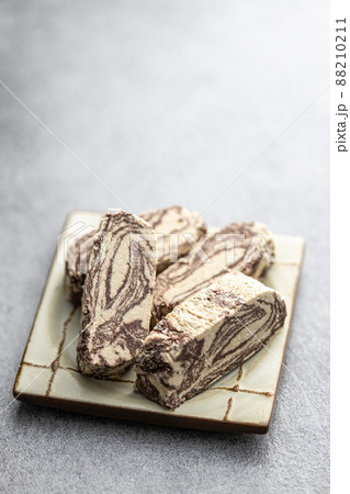 Sweet tahini halva with cocoa flavor. Turkish dessert on plate. Sweet tahini halva with cocoa flavor. Turkish dessert on plate. 88210211