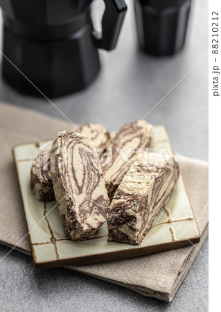 Sweet tahini halva with cocoa flavor. Turkish dessert on plate. Sweet tahini halva with cocoa flavor. Turkish dessert on plate. 88210212