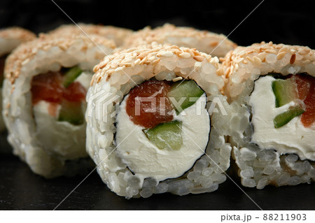 Traditional delicious fresh sushi roll set on a black background