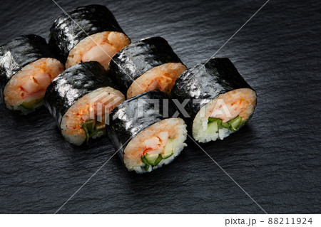 Traditional japanese sushi roll with sea eel, close up isolated on a black background Traditional japanese sushi roll with sea eel, close up isolated on a black background 88211924