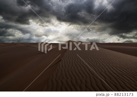 Stormy weather with dramatic clouds in the desert. Arid landscape of the Sahara desert. 88213173