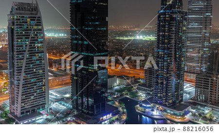 Tall residential buildings at JLT aerial night timelapse, part of the Dubai multi commodities centre mixed-use district. 88216056
