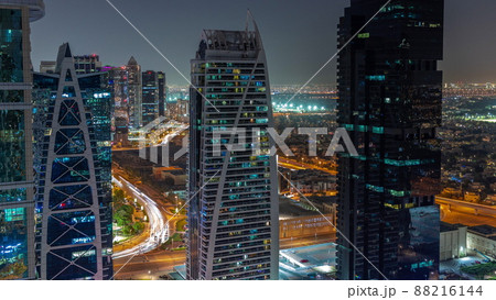 Tall residential buildings at JLT aerial night timelapse, part of the Dubai multi commodities centre mixed-use district. Tall residential buildings at JLT aerial night timelapse, part of the Dubai multi commodities centre mixed-use district. 88216144
