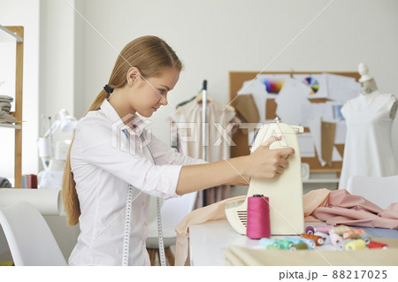 Woman seamstress work with fabric in fashion atelier 88217025
