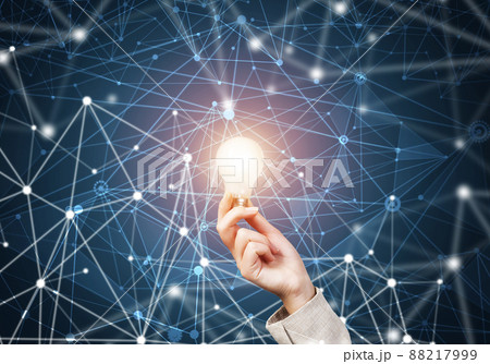 Woman hand holding light bulb and abstract network Woman hand holding light bulb and abstract network 88217999