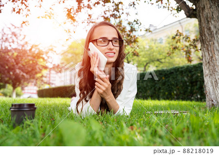woman in the park with phone 88218019