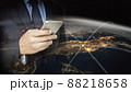 Double exposure of hand hold  smart phone with world background 88218658
