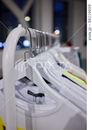 Fashion clothes on clothing rack, Bright colorful cotton shirts on hanger in boutique shop. 88219009