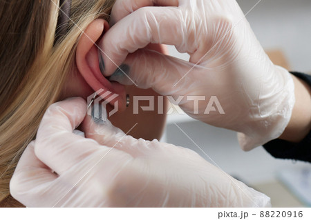 piercings on an ear. Conch and helix piercings close up. 88220916
