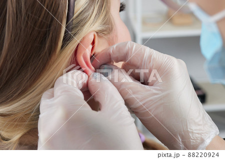piercings on an ear. Conch and helix piercings close up. piercings on an ear. Conch and helix piercings close up. 88220924