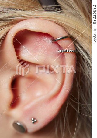 piercings on an ear. Conch and helix piercings close up. 88220932