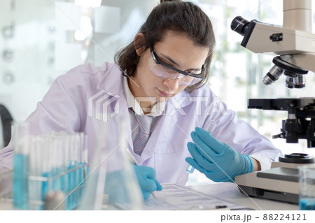 Laboratory diagnosis of synthetic substances, Scientist or researcher examines the substance in vitro and record information, Lab experiments, Researchers scientist working analysis with test tube. Laboratory diagnosis of synthetic substances, Scientist or researcher examines the substance in vitro and record information, Lab experiments, Researchers scientist working analysis with test tube. 88224121