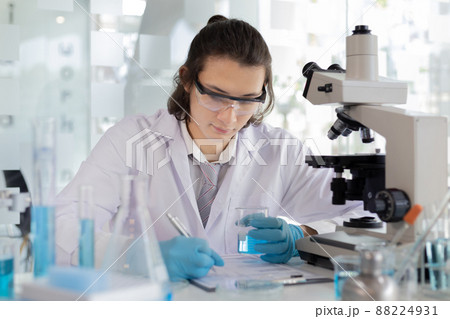 Laboratory diagnosis of synthetic substances, Scientist or researcher examines the substance in vitro and record information, Lab experiments, Researchers scientist working analysis with test tube. Laboratory diagnosis of synthetic substances, Scientist or researcher examines the substance in vitro and record information, Lab experiments, Researchers scientist working analysis with test tube. 88224931