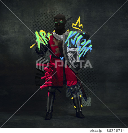 Contemporary art collage. Medieval knight, warrior in balaclava posing isolated over black background with lettering design Contemporary art collage. Medieval knight, warrior in balaclava posing isolated over black background with lettering design 88226714