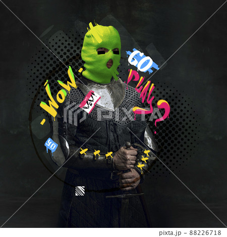 Contemporary art collage. Medieval knight, warrior in neon colored balaclava with letterings around isolated over black background 88226718