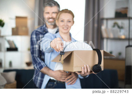 Caucasian couple holding boxes with keys at new flat Caucasian couple holding boxes with keys at new flat 88229743
