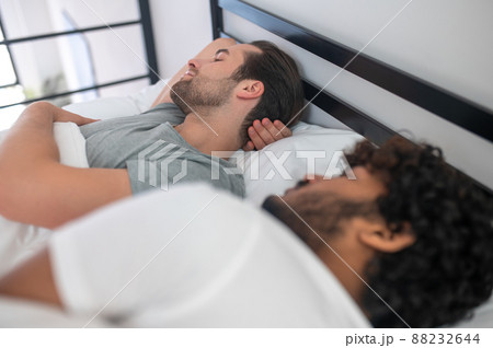 Two gay men dozing in their bedroom Two gay men dozing in their bedroom 88232644
