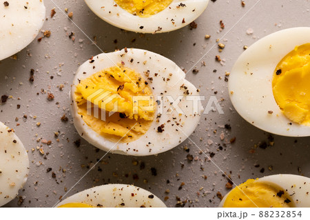 Overhead close-up view of fresh boiled white eggs with peppercorn seasoning Overhead close-up view of fresh boiled white eggs with peppercorn seasoning 88232854