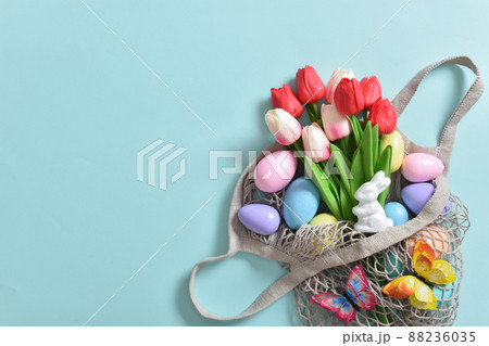 A beautiful bouquet of tulips with a string bag containing painted eggs A beautiful bouquet of tulips with a string bag containing painted eggs 88236035