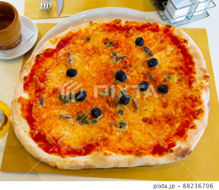 Appetizing Roman pizza with olives on table Appetizing Roman pizza with olives on table 88236706