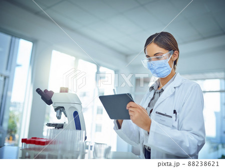 Making it easier to publish her findings to the world. Shot of a female scientist using a digital tablet in a lab. 88238621