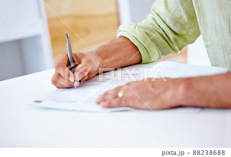 Writing a report. Cropped shot of a businessman signing contracts. Writing a report. Cropped shot of a businessman signing contracts. 88238688