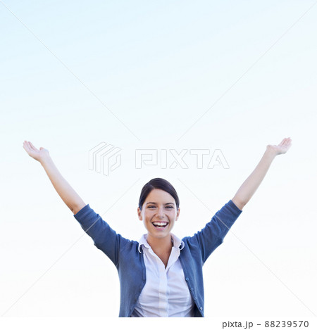 She loves her life. An attractive young woman raising her hands in celebration. She loves her life. An attractive young woman raising her hands in celebration. 88239570
