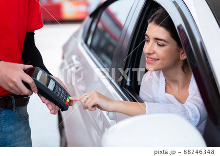 Woman payment terminal after refuel car spending instead of cash. Woman payment terminal after refuel car spending instead of cash. 88246348