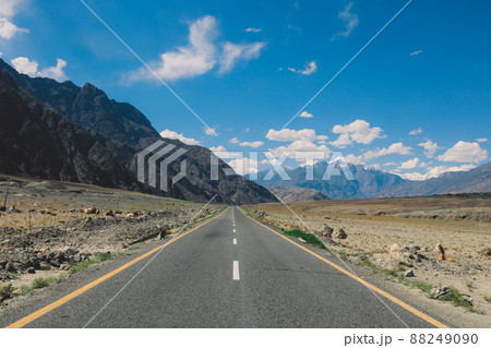 Asphalt Road in the High Gilgit Baltistan Mountains under the Blue Clouds, Pakistan 88249090