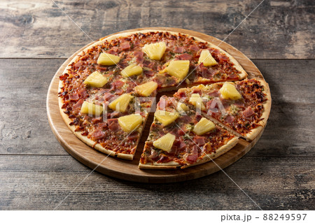 Hawaiian pizza with pineapple,ham and cheese on wooden table	 88249597