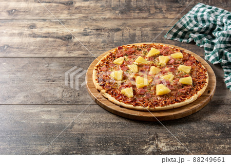 Hawaiian pizza with pineapple,ham and cheese 88249661