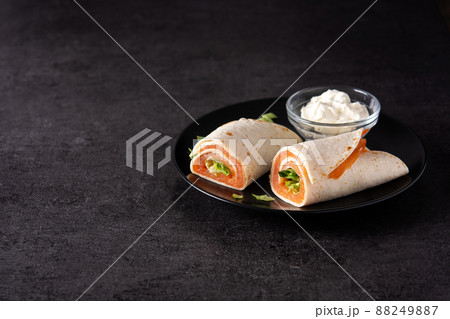 Salmon wrap sandwich roll with cheese and vegetables Salmon wrap sandwich roll with cheese and vegetables 88249887