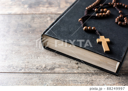 Rosary catholic cross on holy bible isolated on white background	 88249997