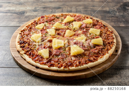 Hawaiian pizza with pineapple,ham and cheese Hawaiian pizza with pineapple,ham and cheese 88250168