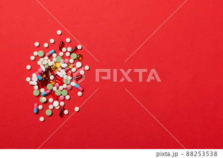 Protective face masks or surgical masks, medicine pills and thermometer on table background. Coronavirus disease. Corona virus concept. Space for text 88253538