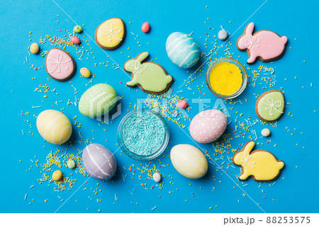holiday preparation Multi colors Easter eggs with cookies on colored background . Pastel color Easter eggs. holiday concept with copy space 88253575