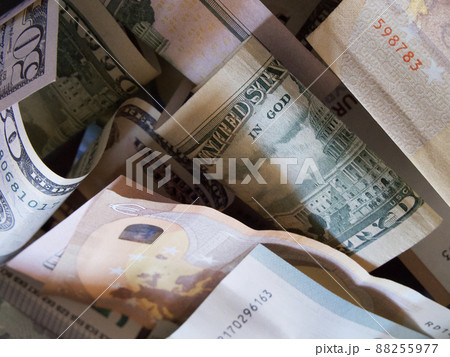 Cash banknotes dollars and euros are mixed up, a close-up shot. Cash banknotes dollars and euros are mixed up, a close-up shot. 88255977