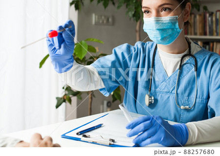 Female caucasian doctor holding a swab collection stick 88257680
