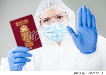 Security officer at airport customs security check holding passport Security officer at airport customs security check holding passport 88258431