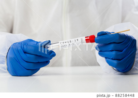 Lab technician holding swab collection kit Lab technician holding swab collection kit 88258448