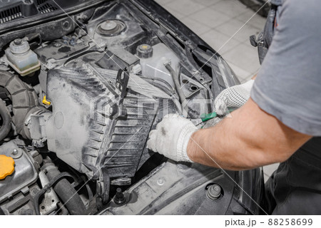 Mechanic repairing engine on a car using wrench. Close up of hands 88258699