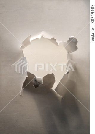 Hole punched in a paper sheet 88259187