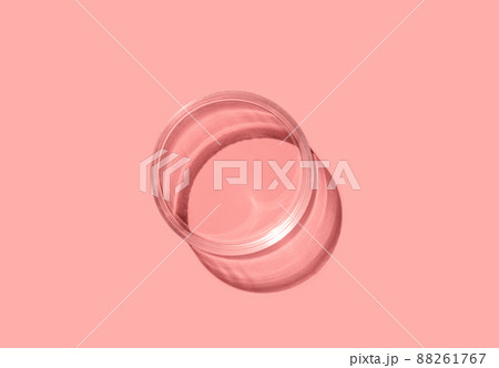 Empty laboratory glass petri for serum, oil, beauty products on orange background. Natural medicine, cosmetic research, bio science. Concept of skincare and analysis. Dermatology. Flat lay, top view Empty laboratory glass petri for serum, oil, beauty products on orange background. Natural medicine, cosmetic research, bio science. Concept of skincare and analysis. Dermatology. Flat lay, top view 88261767