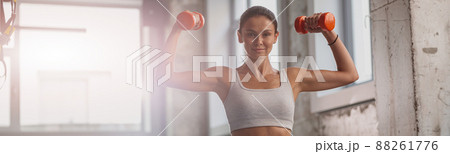 Slender lady working out in the gym 88261776