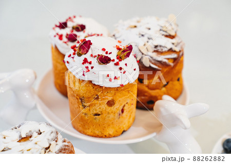 decorated panettones and cruffins on serving plate with rabbits. easter cakes. decorated panettones and cruffins on serving plate with rabbits. easter cakes. 88262882