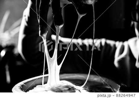 focus on slime covered hands with strings of gooey webbing down 88264947